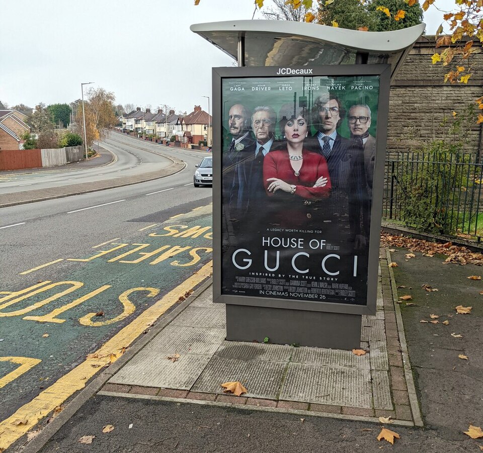 House of Gucci film advert on a bus shelter in Newport, Wales